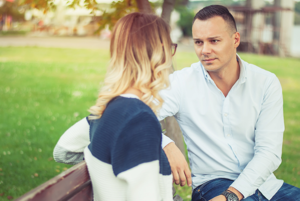 Couple talking outdoors in a park - How to Know When a Libra man is Not Interested