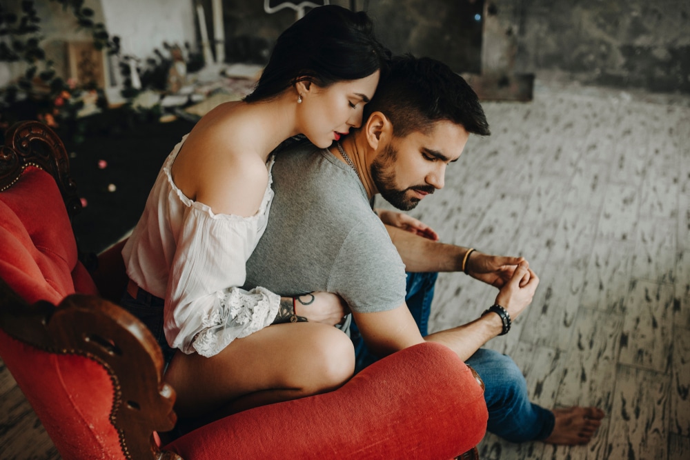 Very beautiful couple sitting on vintage red chair - The Libra Man with Leo Rising