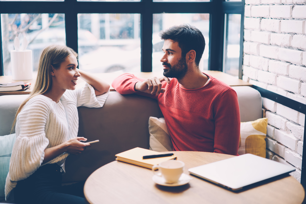 Young woman and man talking during first date in cozy coffee shop enjoying free time together - How to Know When a Libra man is Not Interested