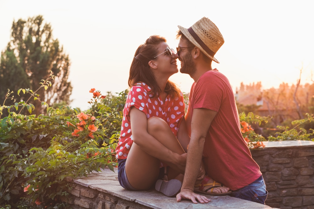 Young couple in love on the balcony - The Libra man with Capricorn Rising